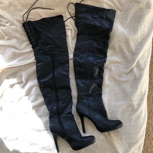 Thigh high over the knee  black “leather” boots.